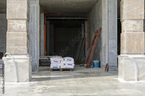 construction site with cement bags and scaffolding parts.