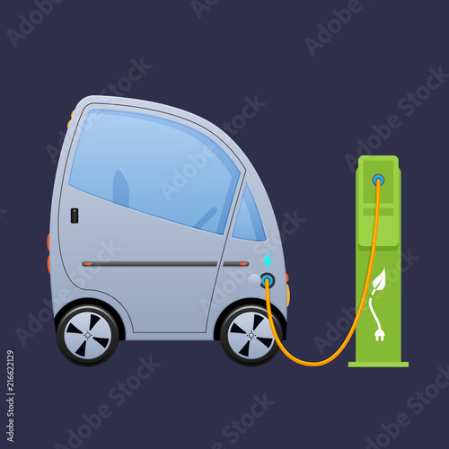 Beautiful single-seat electric vehicle, automobile near city's charging electric station.