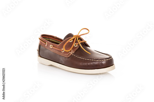 Close up of a brown mens top-sider boat shoes with white sole on white background with reflection. Fashion advertising shoes photos.
