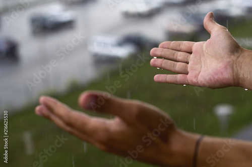 man's hands under rain © dvulikaia