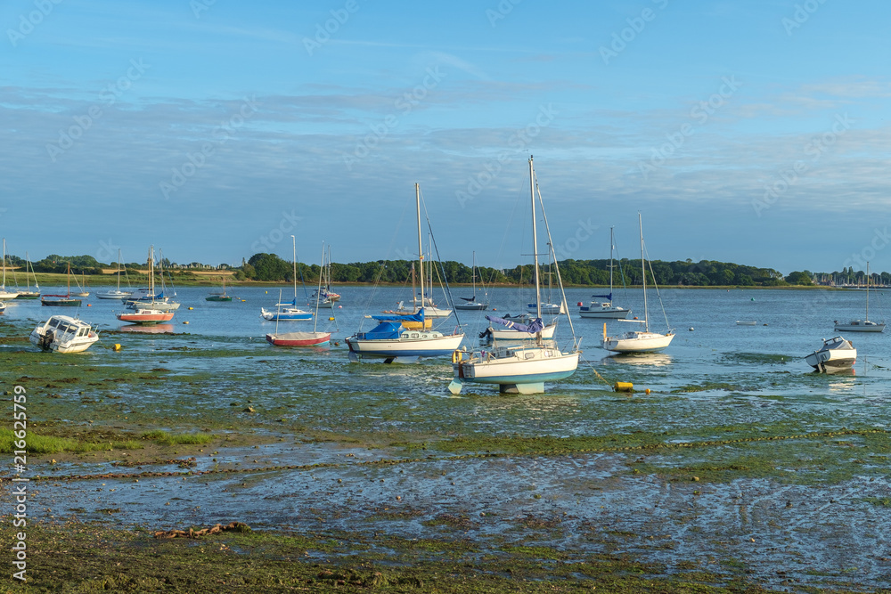 Small boats and dinghies at low tide, near Dell Quay, Chichester Harbour, England, UK. Small boats and dinghies at low tide, near Dell Quay, Chichester Harbour, England, UK.