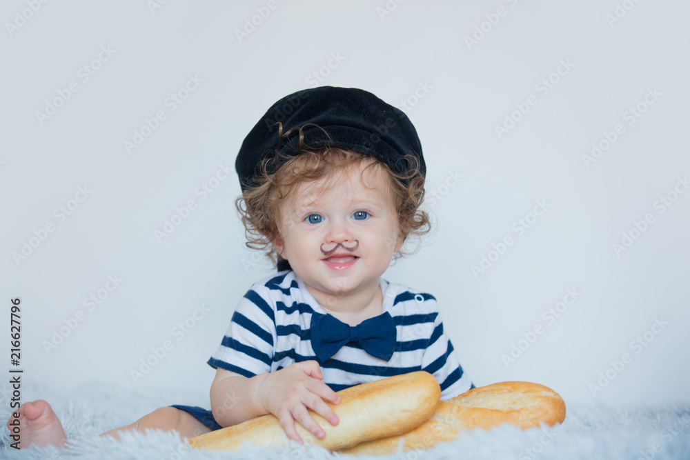 Little baby with mustache, beret and baguette on white background. Little baby with mustache, beret and baguette on white background.