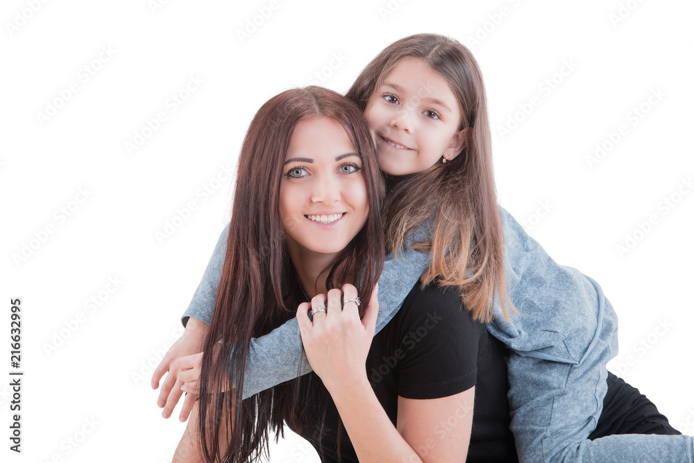 Loving mother and her daughter child girl playing and hugging on white background. Concept of happy. Studio shoot Loving mother and her daughter child girl playing and hugging on white background. Concept of happy. Studio shoot