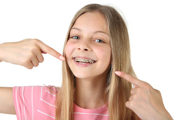 Young smiling girl with dental braces on white background