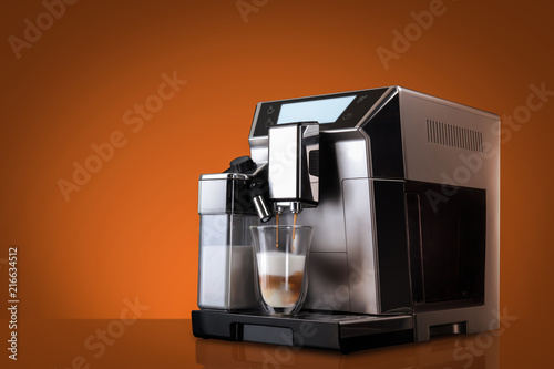 Obraz na płótnie Coffee machine without flying coffee beans across it on orange background