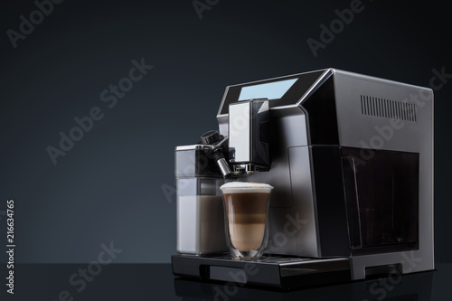 Foto Coffee machine without flying coffee beans across it on dark background