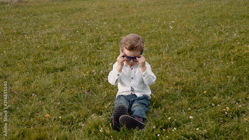 child in glasses on the grass child in glasses on the grass