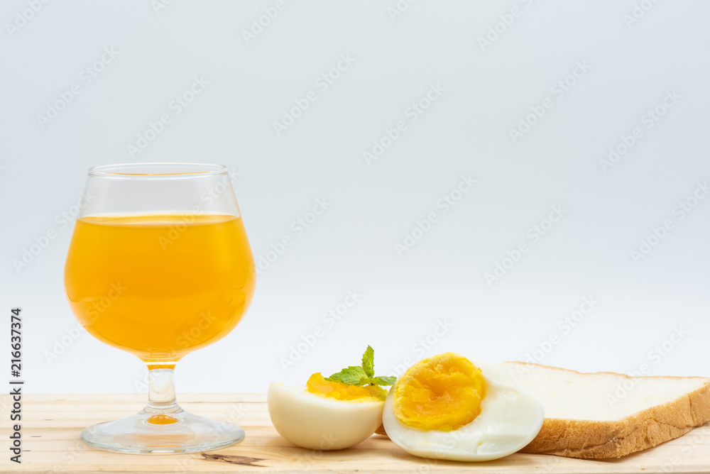 Fototapeta premium Orange juice in glass with heathy foods on wood table