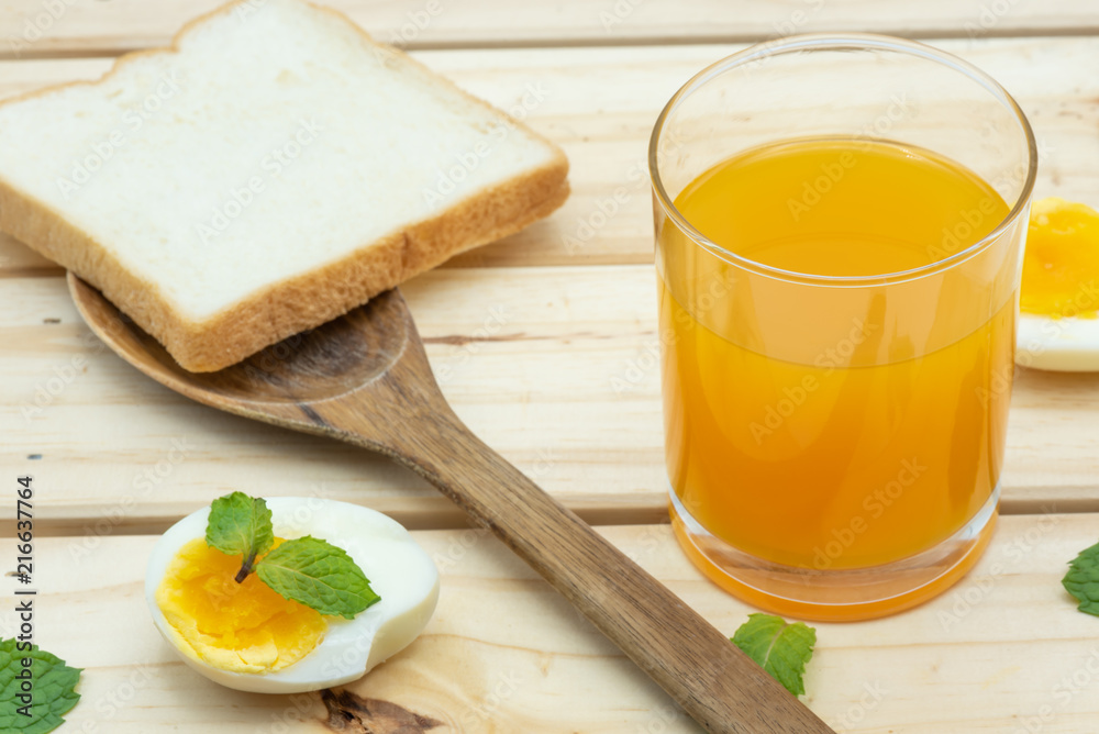 Orange juice in glass with heathy foods on wood table Orange juice in glass with heathy foods on wood table