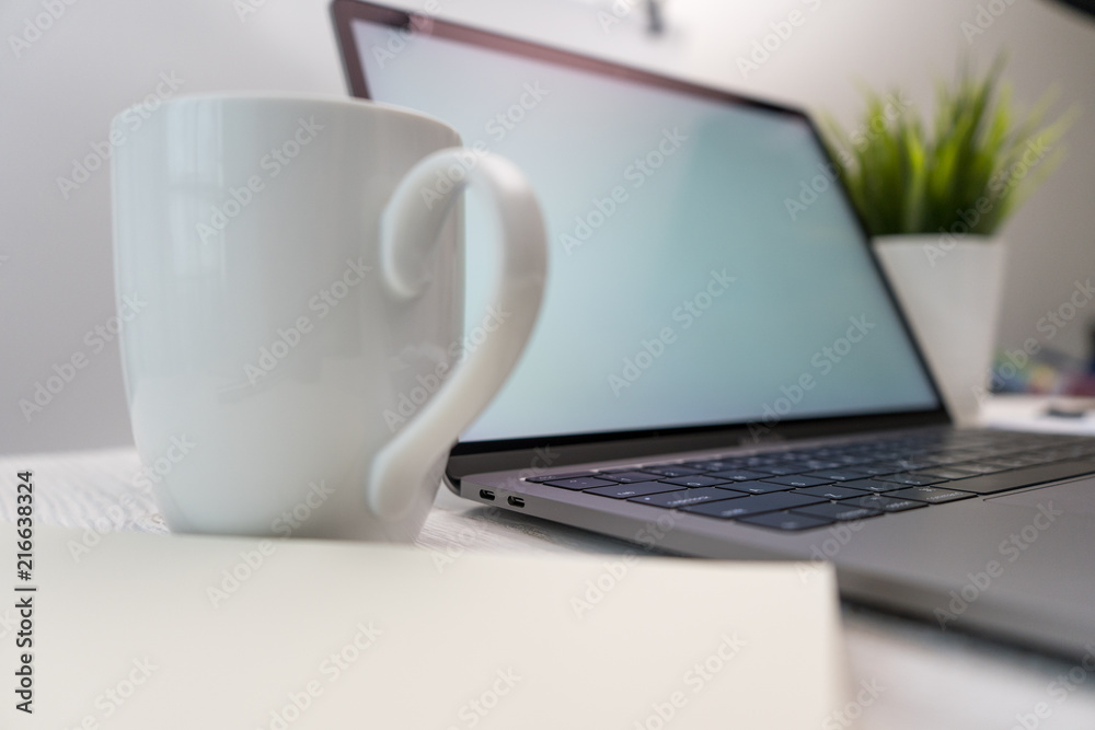 Side view shopping online on laptop and smartphone and working wooden desk business with coffee, a little tree. Side view shopping online on laptop and smartphone and working wooden desk business with coffee, a little tree.