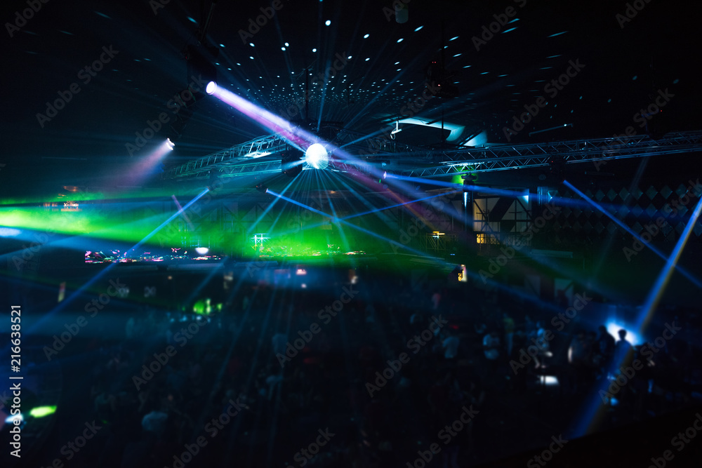 Fototapeta premium Defocused entertainment concert lighting on stage, blurred disco party.