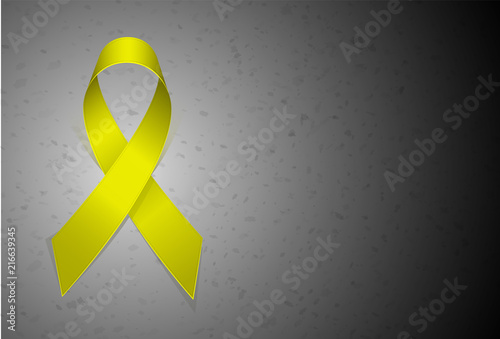 Yellow textile ribbon emblem of fight against suicide. Gray sad background similar to concrete. Place for text or article.