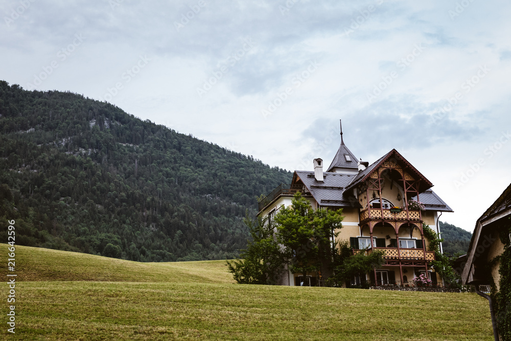 Old house in front of a mountain in austria Old house in front of a mountain in austria