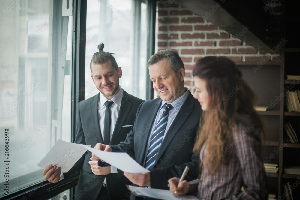 Fototapeta premium business partners discussing business documents standing in the 