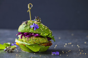Avocado sandwich with green vegan burger,  roast yellow pepper and pickled red cabbage