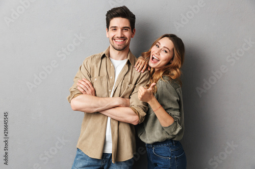 Portrait of a cheerful young couple standing together photo