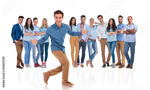 excited young man invites you in his casual group