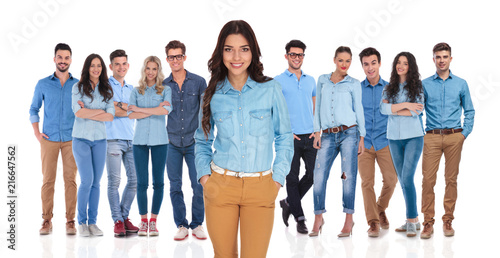 relaxed casual woman standing in front of the team