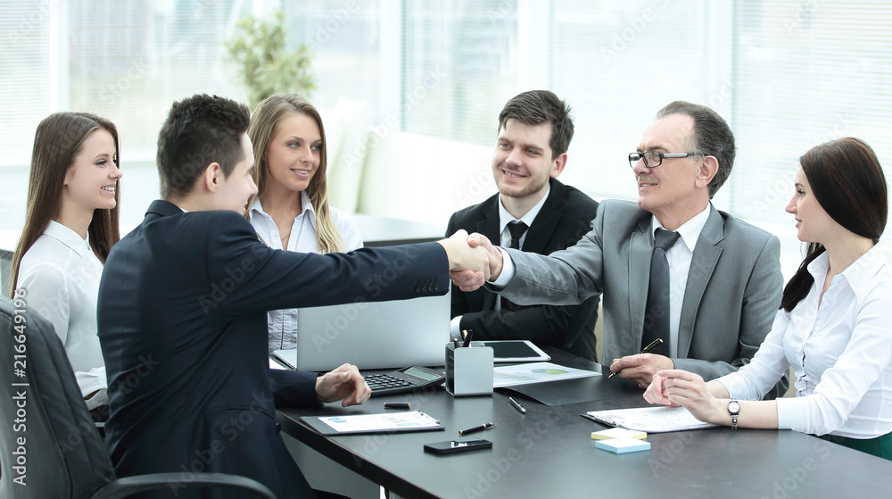 business partners shaking hands after a successful transaction business partners shaking hands after a successful transaction