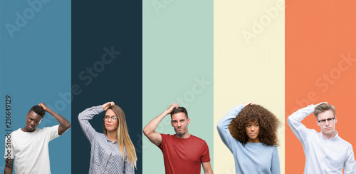 Group of people over vintage colors background confuse and wonder about question. Uncertain with doubt, thinking with hand on head. Pensive concept.