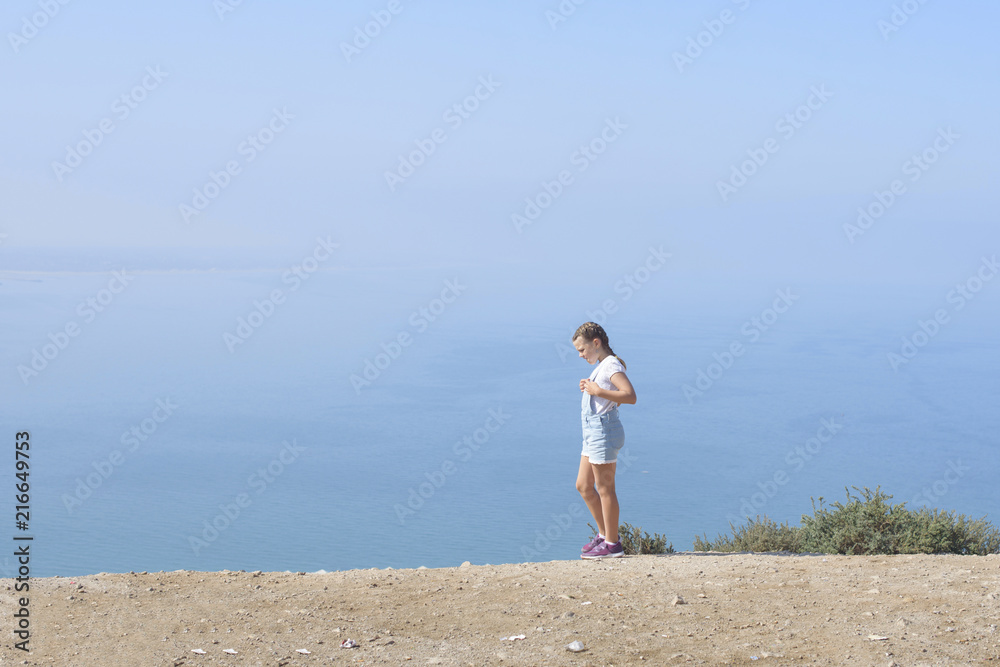 teen girl walking on top of mountain