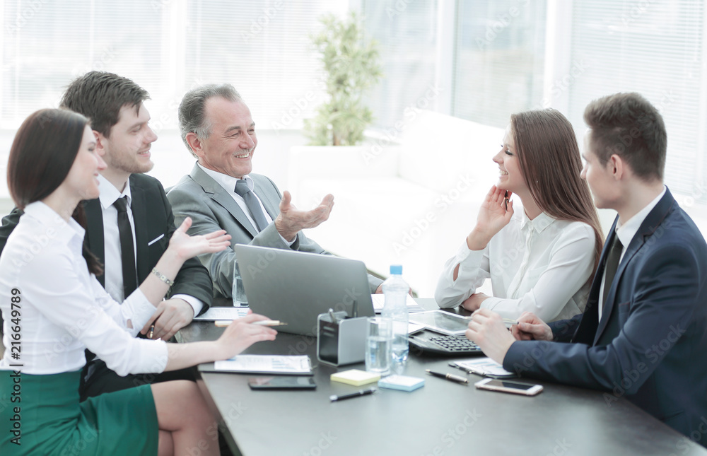 business colleagues talking at Desk in the office business colleagues talking at Desk in the office