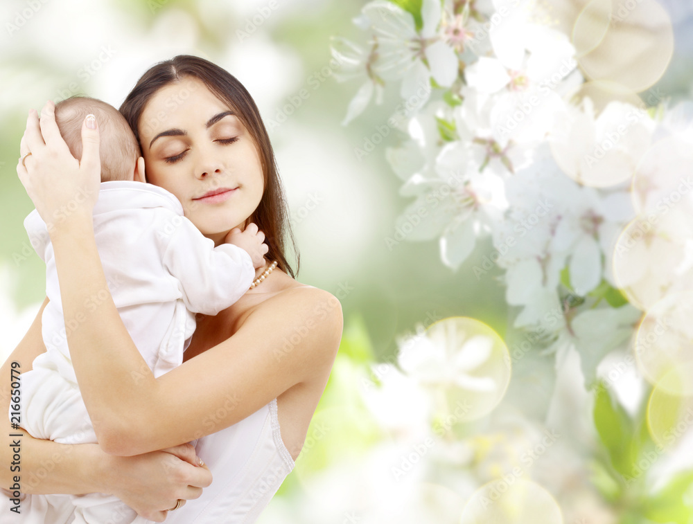 family and motherhood concept - happy young mother holding little baby over cherry blossom background family and motherhood concept - happy young mother holding little baby over cherry blossom background