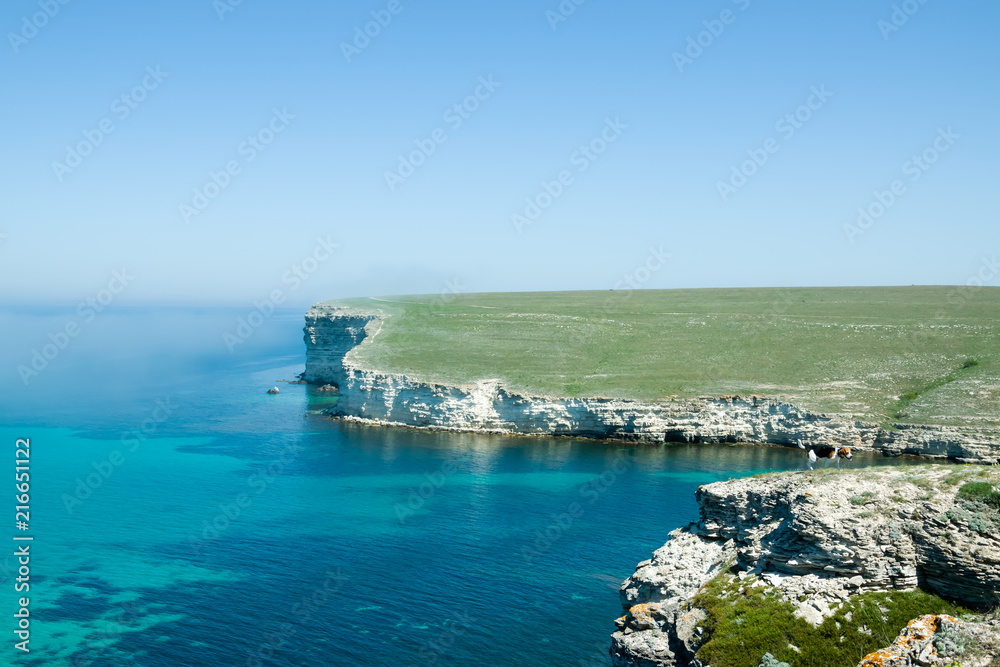 Beautiful rock off the coast of the sea. Turquoise water, blue sky, incredible landscape