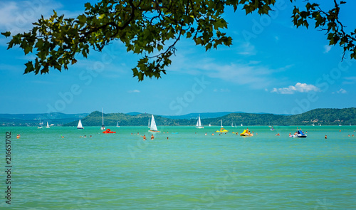 Tourists and sailboats on l...