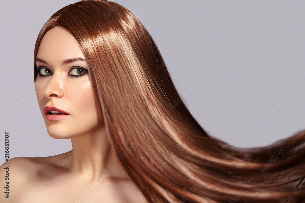 Obraz premium Fashion Model Woman with Beautiful Long Blowing Hair. Glamour Sexy Woman with Healthy and Beauty Flying Brown Hair