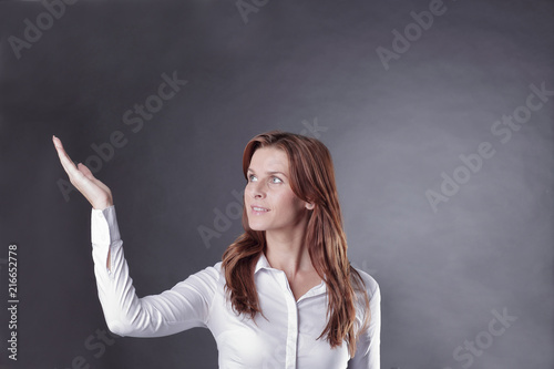 business woman pointing on copy space.isolated on dark