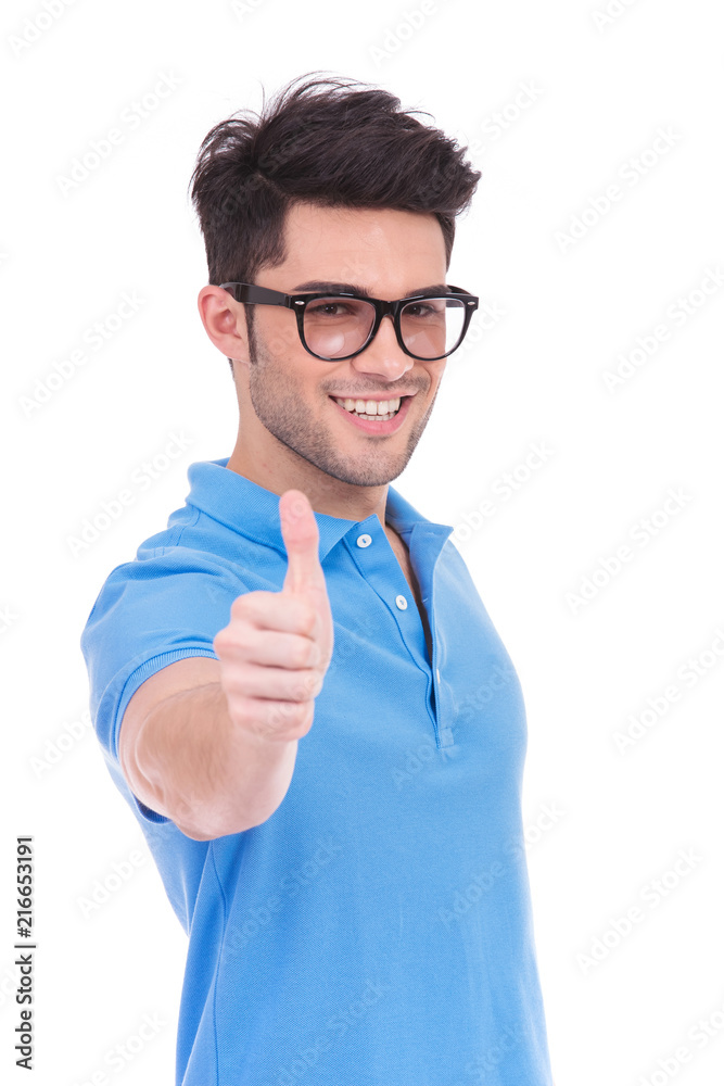 young casual man making the ok thumbs up hand sign young casual man making the ok thumbs up hand sign