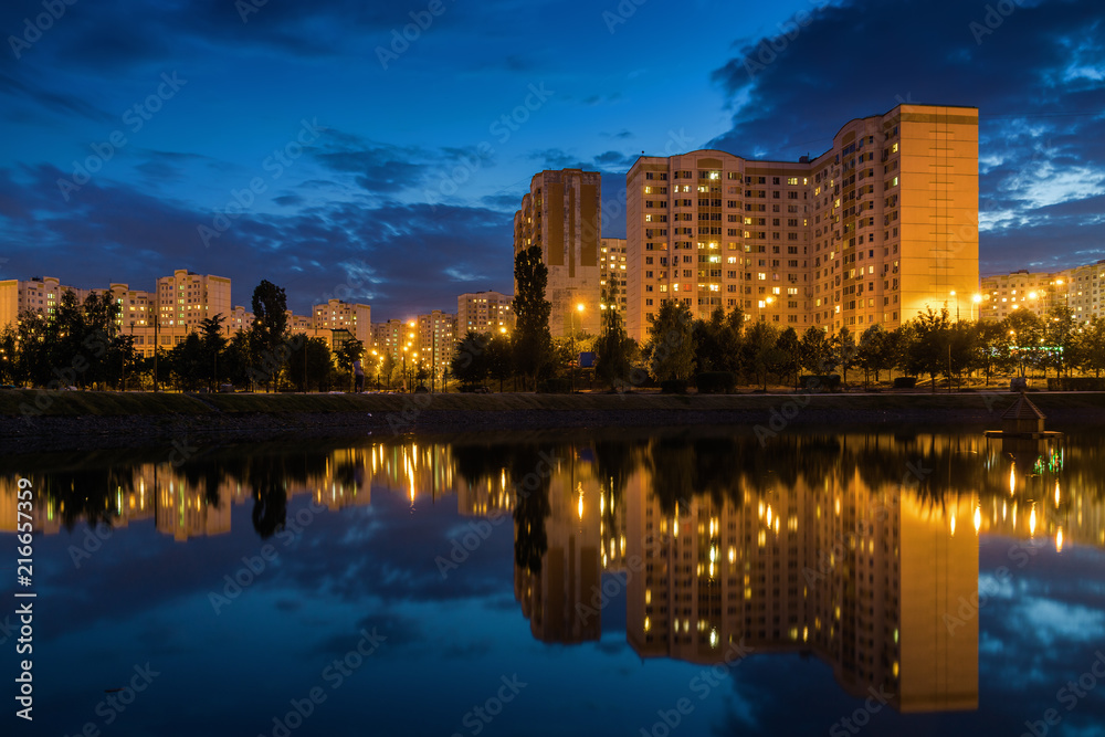 Sunny view of city district with pond in the south of Moscow, Russia.