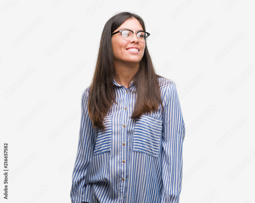 Young beautiful hispanic business woman looking away to side with smile on face, natural expression. Laughing confident.