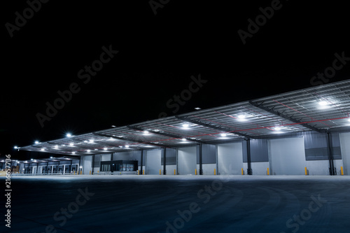 Illuminated exterior of a factory, industrial style building. Night time.