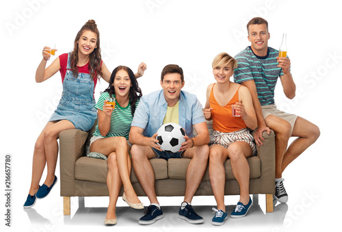 entertainment, leisure and people concept - group of happy smiling friends or football fans with soccer ball sitting on sofa with non alcoholic drinks over white background © Syda Productions