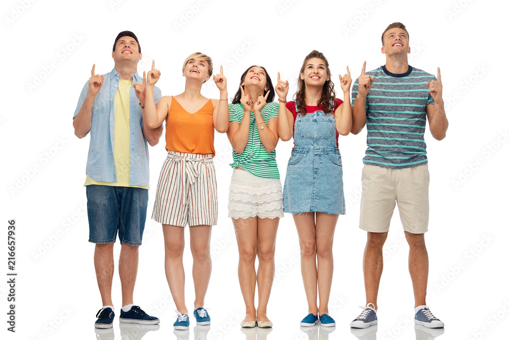 friendship and people concept - group of happy smiling friends looking and pointing fingers up over white background