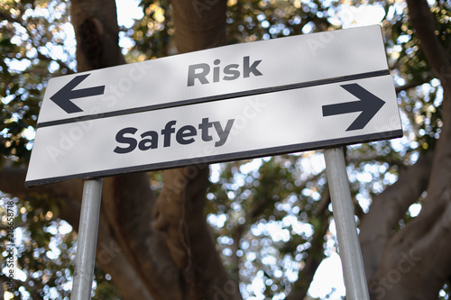 "Risk or Safety" decision road sign with opposite direction arrows. Money nvestment decision concept.