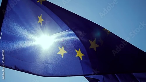 Waving European Union flag in the wind with a blue sky.