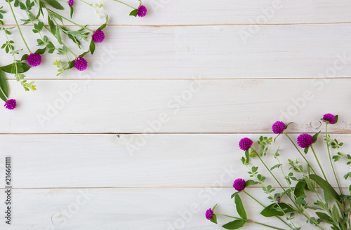 wild beautiful flowers on white wooden background