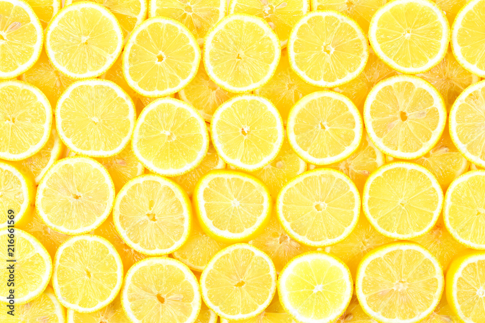 A slices of fresh juicy yellow lemons.  Texture background, pattern.