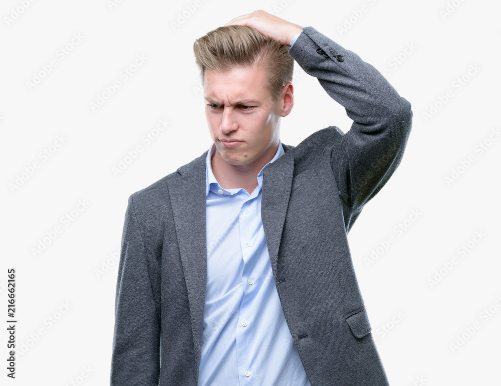 Young handsome blond business man confuse and wonder about question. Uncertain with doubt, thinking with hand on head. Pensive concept. Young handsome blond business man confuse and wonder about question. Uncertain with doubt, thinking with hand on head. Pensive concept.