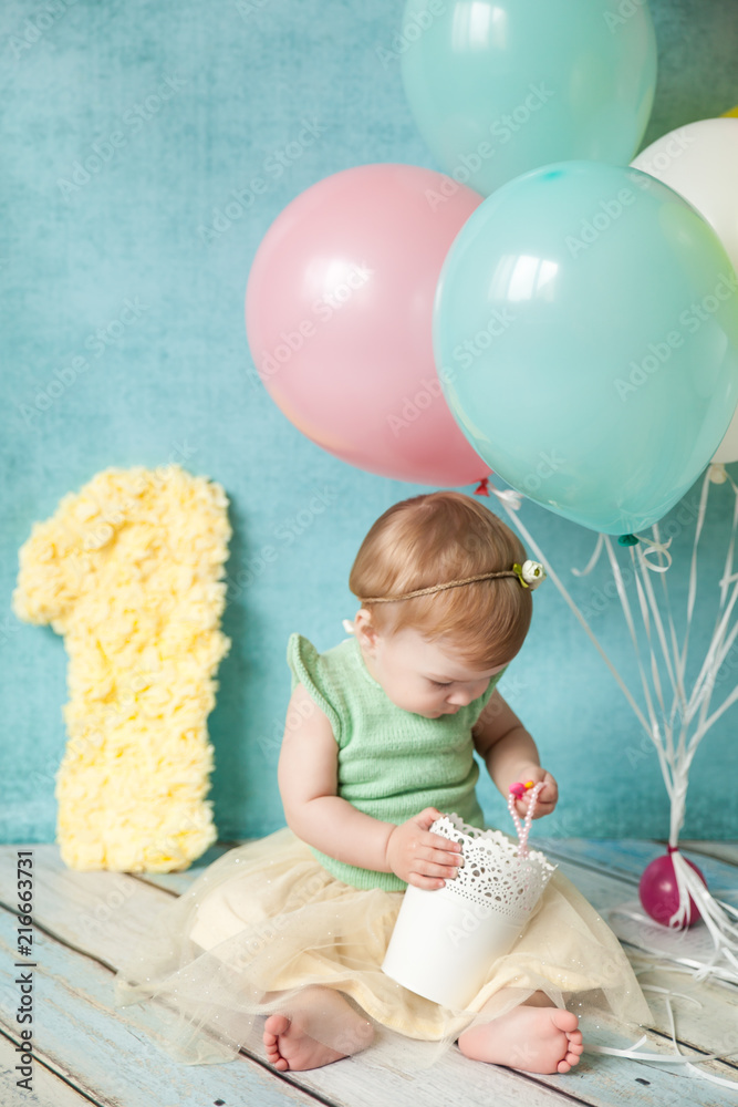 Fototapeta premium First birthday party. Cute little girl