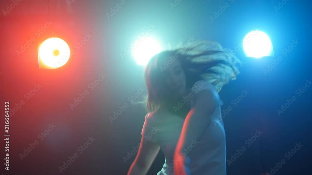 Young girl dancing in color light Young girl dancing in color light