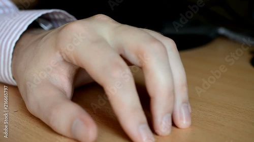 Man knocks fingers on the table photo