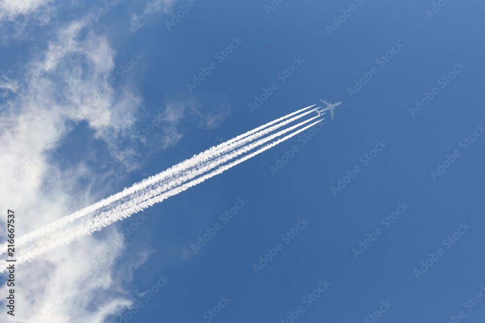 Airplane in cloudy sky with an inverse trace Airplane in cloudy sky with an inverse trace