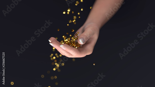 golden crystals fall into the hand
