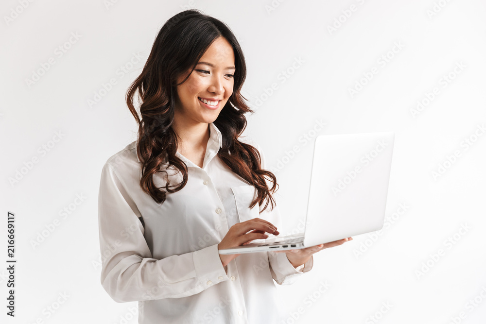 Smiling young asian businesswoman standing Smiling young asian businesswoman standing