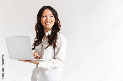 Smiling young asian businesswoman standing photo
