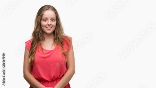 Young blonde woman wearing pink dress with a happy face standing and smiling with a confident smile showing teeth © Krakenimages.com